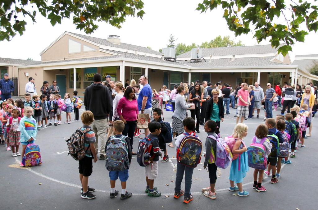 As family members take photos kindergarteners line up for school on the first day of school at Corona Creek School in Petaluma on Tuesday, August 18, 2015. (SCOTT MANCHESTER/ARGUS-COURIER STAFF)