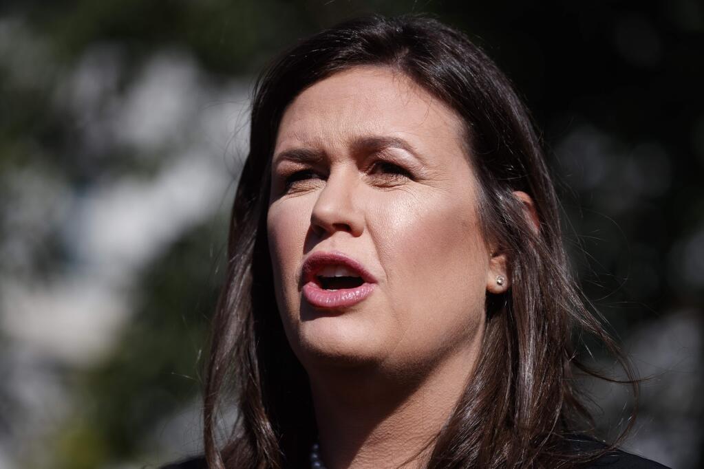 In this June 11, 2019, photo, White House press secretary Sarah Sanders talks with reporters outside the White House in Washington. (AP Photo/Evan Vucci)