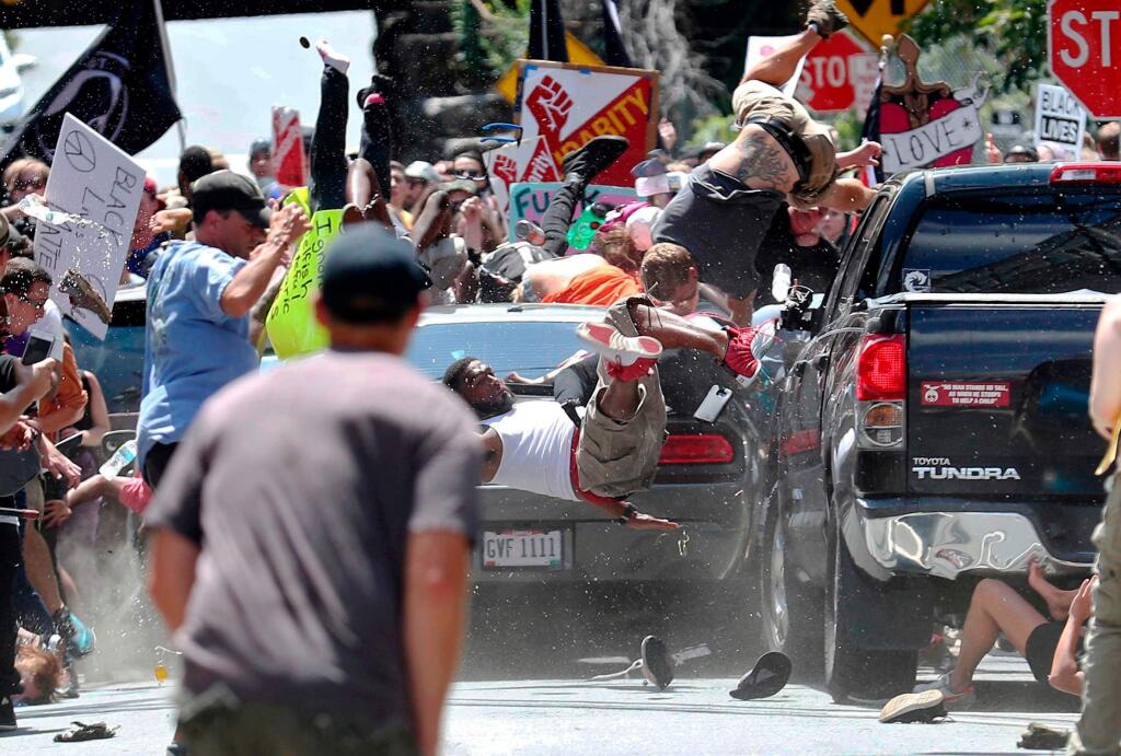 In this Aug. 12, 2017, photo by Ryan Kelly of The Daily Progress, people fly into the air as a car drives into a group of protesters demonstrating against a white nationalist rally in Charlottesville, Va. The photo won the 2018 Pulitzer Prize for Breaking News Photography, announced Monday, April 16, 2018, at Columbia University in New York. (Ryan Kelly/The Daily Progress via AP)