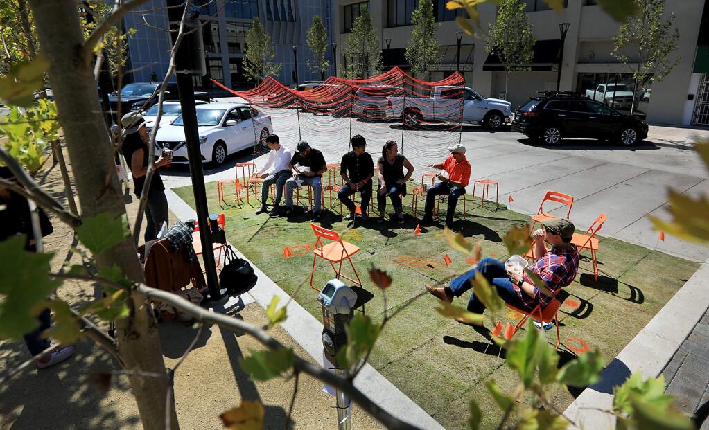 Two parking spots were used to set up a Parklet along the west side of Old Courthouse Square in Santa Rosa, Friday Sept. 15, 2017. (Kent Porter / The Press Democrat) 2017