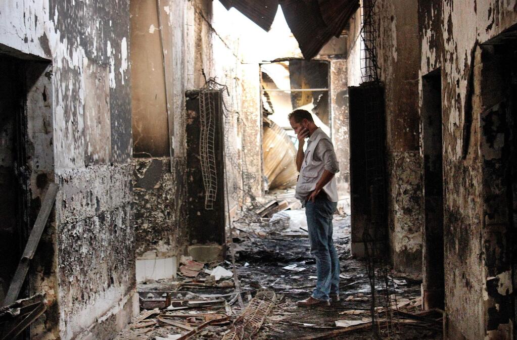 An employee of Doctors Without Borders walks inside the charred remains of the organization's hospital after it was hit by a U.S. airstrike in Kunduz, Afghanistan. (NAJIM RAHIM / Associated Press, 2015)
