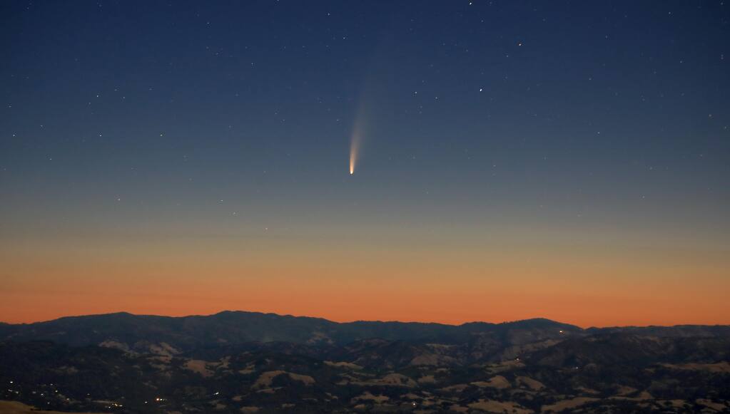 Comet NEOWISE displays its own July fireworks as a trail of dust and gas follows the arc of the comet in the pre-dawn sunrise above the Mayacamas Mountains of Sonoma and Lake Counties, Wednesday, July 8, 2020. NEOWISE will be visible just before early dawn in the low northeast sky until July 12, and will then be visible at dusk beginning July 13 on the low northwest horizon. The comet C/2020 F3 was discovered on March 27, 2020, nearly 326 miles above the Earth's surface by Near Earth Object Wide-field Infrared Survey Explorer (NEOWISE), named after the space telescope launched by NASA in 2009. (Kent Porter / The Press Democrat) 2020