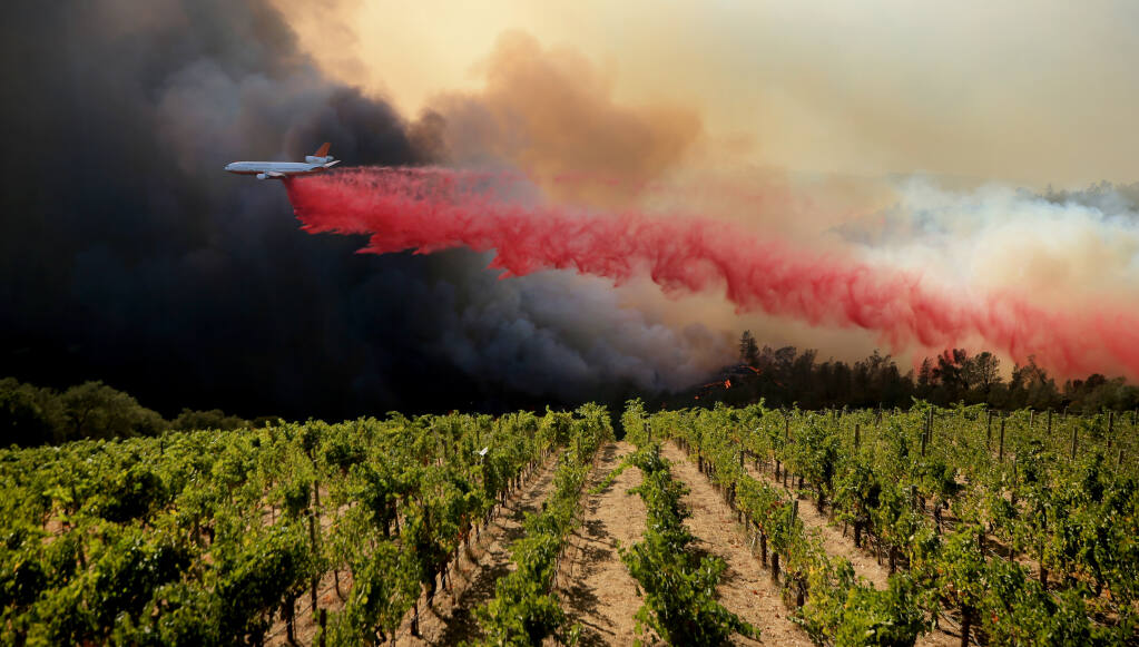 A DC-10 air tanker drops suppressant on the left flank of the Glass Fire along Crystal Springs Road, running towards Silverado Trail on Sunday, Sept. 27, 2020. (Kent Porter / The Press Democrat) 2020