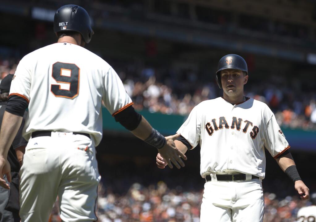 San Francisco Giants' Joe Panik, right, is greeted by Brandon Belt (9) after both scored on Eduardo Nunez's double against the Washington Nationals during the fourth inning of a baseball game in San Francisco, Saturday, July 30, 2016. (AP Photo/Tony Avelar)