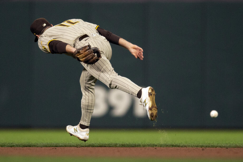 San Diego Padres second baseman Adam Frazier can't get to an RBI single by San Francisco Giants' Tommy LaStella during the fourth inning of a baseball game, Tuesday, Sept. 14, 2021, in San Francisco. (AP Photo/D. Ross Cameron)