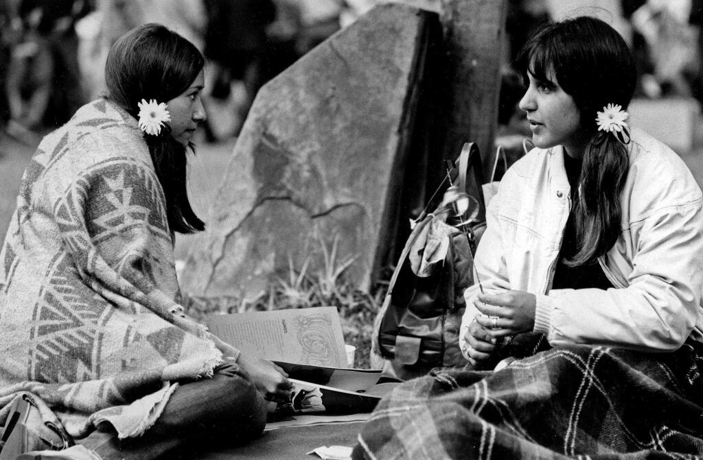 In this June 17, 1967 photo are two women at the Monterey Pop Festival in Monterey, Calif. Before Burning Man and Bonnaroo, Coachella and Lollapalooza, Glastonbury and Governors Island, there was Monterey Pop. Fifty years ago in June 2017, the three-day concert in the San Francisco Bay area gave birth to the 'Summer of Love'' and paved the way for today's popular festivals. (Monterey Herald via AP)