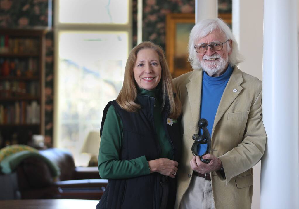 DAISY Foundation co-founders Bonnie and Mark Barnes hold a 'Healers Touch' sculpture given to recipients of the DAISY Award For Extraordinary Nurses. Photo taken at their home on Wednesday, January 2, 2019 in Glen Ellen, California . (BETH SCHLANKER/The Press Democrat)