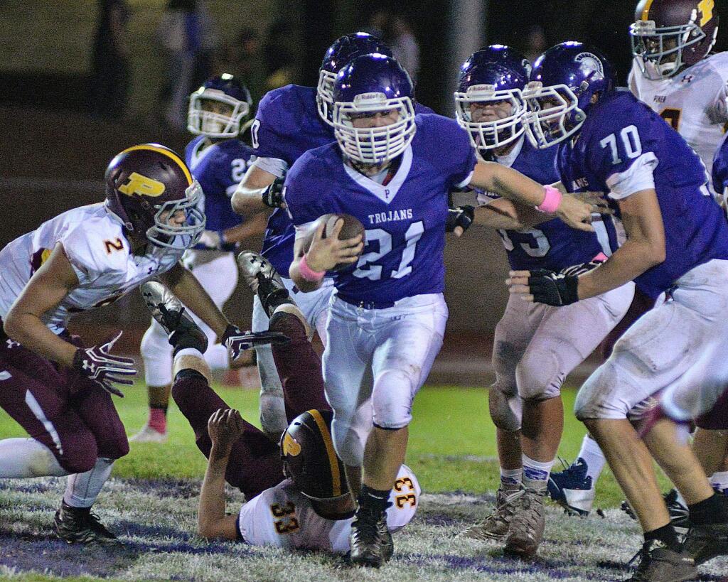 SUMNER FOWLER/FOR THE ARGUS-COURIERPetaluma's Jacob Rollstin steps through a big hole, and is off for a good gain in his team's 28-0 win over Piner. Petaluma tries to extend a two-game winning streak Friday night at Healdsburg.