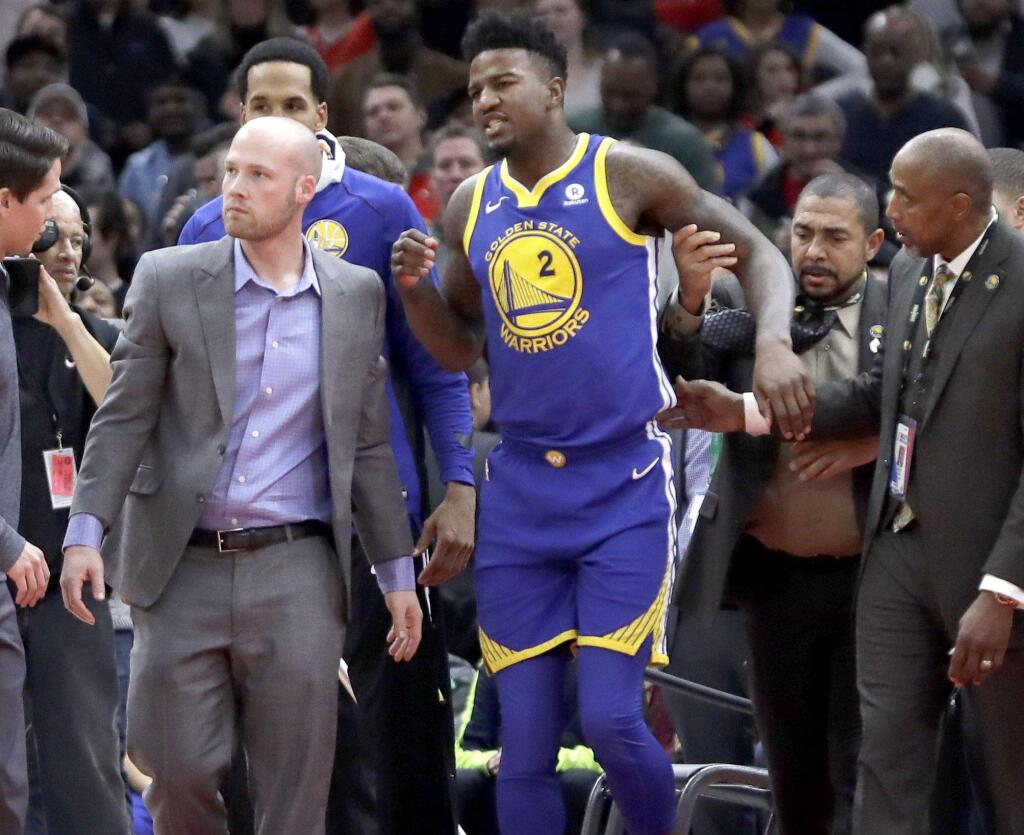 The Golden State Warriors' Jordan Bell is helped to his feet after injuring himself on a dunk by the Chicago Bulls' Robin Lopez during the first half Wednesday, Jan. 17, 2018, in Chicago. (AP Photo/Charles Rex Arbogast)