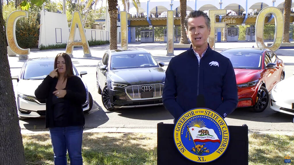 This screen shot from pool video shows California Gov. Gavin Newsom announcing Wednesday, Sept. 23, 2020 that the state will halt sales of new gasoline-powered passenger cars and trucks by 2035, in Sacramento, Calif. On Wednesday he ordered state regulators to come up with requirements to meet that goal. California would be the first state with such a rule, though Germany and France are among 15 other countries that have a similar requirement. (Pool via AP)