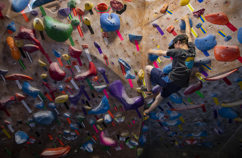 Edward Harper, 12, Vertex youth climbing team member, practices foot and hand holds at Vertex in Santa Rosa Friday  April 15, 2022.  Vertex Climbing Gym recently won the championship of the Youth Climbing League, a top-rope and bouldering competition league featuring teams from all over the Bay Area. (Chad Surmick / The Press Democrat)