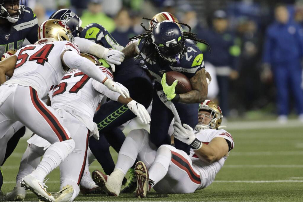 The Seattle Seahawks' Marshawn Lynch carries on a fourth-and-one but is pulled down short during the first half against the San Francisco 49ers, Sunday, Dec. 29, 2019, in Seattle. (AP Photo/Stephen Brashear)