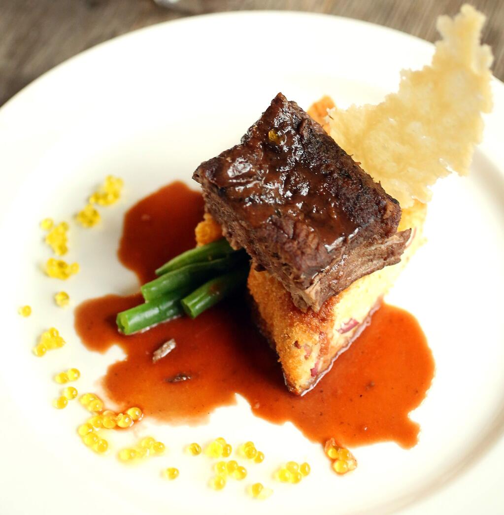 Adolfo Veronese, owner of Aventine in Glen Ellen, made a Braised Boneless Short Rib over a Red Cerignola Olive Risotto Cake with a Parmesan Crips and a Ruby Red Port Sauce with Extra Virgin Olive Oil Caviar, Friday, January 16, 2015. (Crista Jeremiason/The Press Democrat)