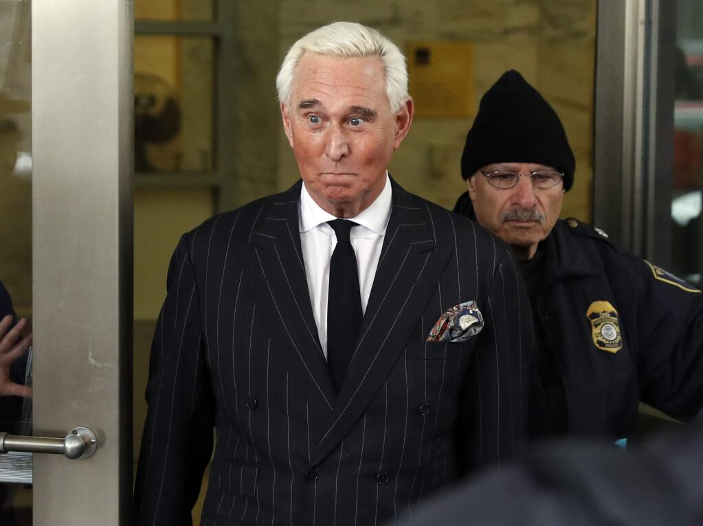 FILE - In this Feb. 1, 2019, file photo, former campaign adviser for President Donald Trump, Roger Stone, leaves federal court in Washington. President Donald Trump's longtime confidant Stone has apologized to the judge presiding over his criminal case for an Instagram post featuring a photo of her with what appears to be the crosshairs of a gun. Stone and his lawyers filed a notice Monday night, Feb. 18, saying Stone recognized 'the photograph and comment today was improper and should not have been posted.' (AP Photo/Pablo Martinez Monsivais, File)