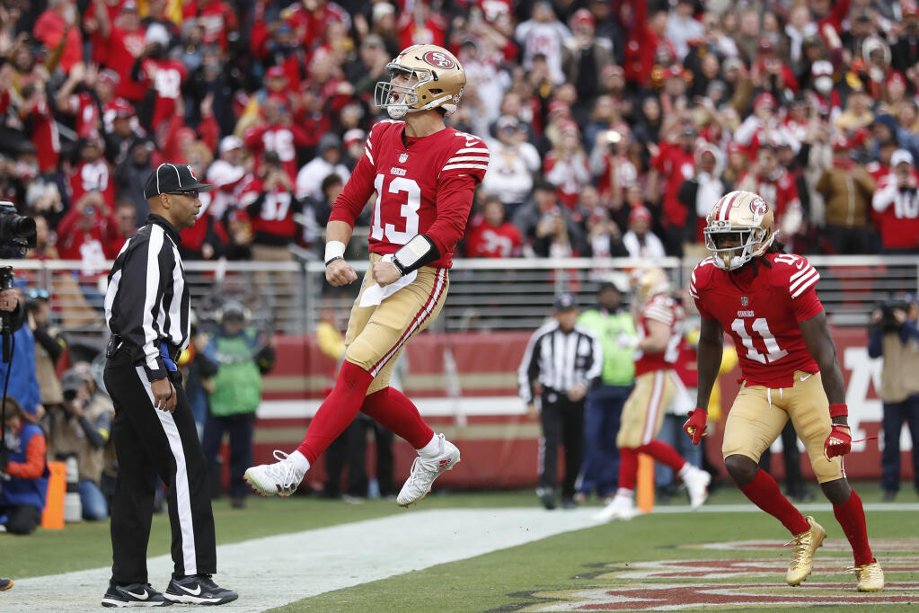 San Francisco 49ers quarterback Brock Purdy (13) celebrates after running for a touchdown against the Tampa Bay Buccaneers during the first half of an NFL football game in Santa Clara, Calif., Sunday, Dec. 11, 2022. (AP Photo/Jed Jacobsohn)