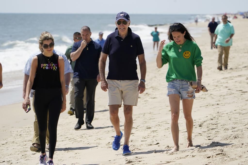 President Joe Biden walks on the beach with his granddaughter Natalie Biden, left, and his daughter Ashley Biden, right, Monday, June 20, 2022 at Rehoboth Beach, Del. (AP Photo/Manuel Balce Ceneta)