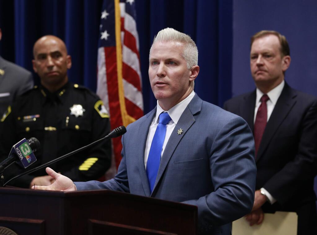 Yolo County District Attorney Jeff Reisig discusses the arrests of 31 people he said are connected to a violent, drug-running multi-state street gang, during a news conference Wednesday, Feb. 14, 2018, in Sacramento, Calif. Twenty-nine suspects were arrested on drug and weapon charges across 10 Northern California counties, as well as one arrest each in two other states. Officials say they were directed by two inmate street gang members who used smuggled cellphones to communicate from inside Pelican Bay State Prison. (AP Photo/Rich Pedroncelli)