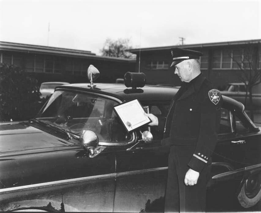 Former Petaluma Police Chief Noonie Del Maestro stands by his car in 1963. (Sonoma County Library)