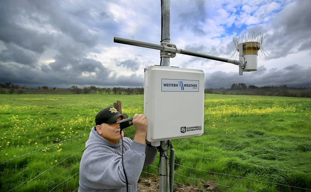 Deputy Jose Acevedo of the Sonoma County Sheriff's Department engraves a numeric code on a weather station Wednesday Feb. 17, 2016 at the Denner Ranch in Santa Rosa, as part of an effort to thwart theft of farm equipment and make it easier for authorities to return stolen items after they are recovered. (Kent Porter / Press Democrat) 2016