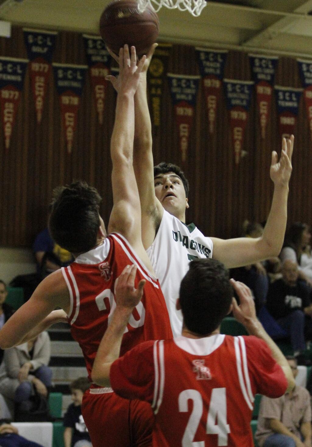 Bill Hoban/Index-TribuneSonoma's Tyler Garrett reaches for a rebound in a recent game. The Dragons Wednesday won their first-round game in the Dixon Ram Jam Winter Classic and advanced to the semi-finals on Thursday.