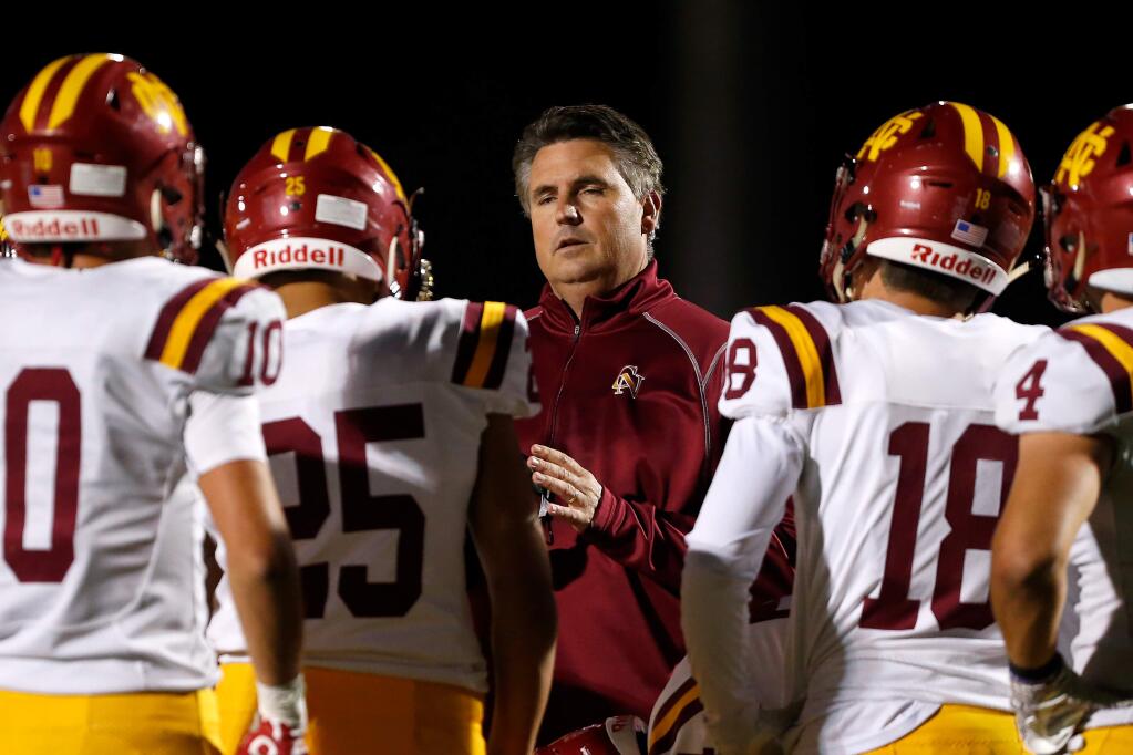 Cardinal Newman head coach Paul Cronin comes out to talk with his defense after they repeatedly made false start penalties during the first half between Cardinal Newman and Rancho Cotate high schools, in Rohnert Park on Friday, Oct. 4, 2019. (Alvin Jornada / The Press Democrat)