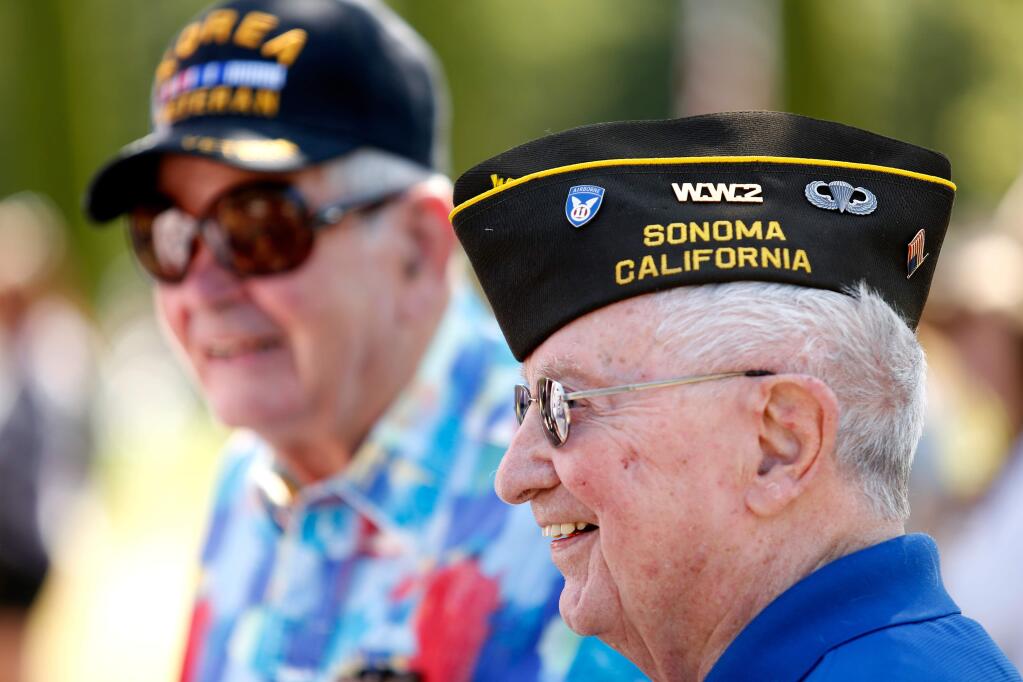 World War II Army veteran Bob Rowntree, right, and Korean War Marine Corps veteran Jim McCombs talk with other veterans during the 58th annual Sonoma Valley Joint Memorial Day Observance at Sonoma Veterans Memorial Park in Sonoma on Monday, May 30, 2016. (Alvin Jornada / The Press Democrat)