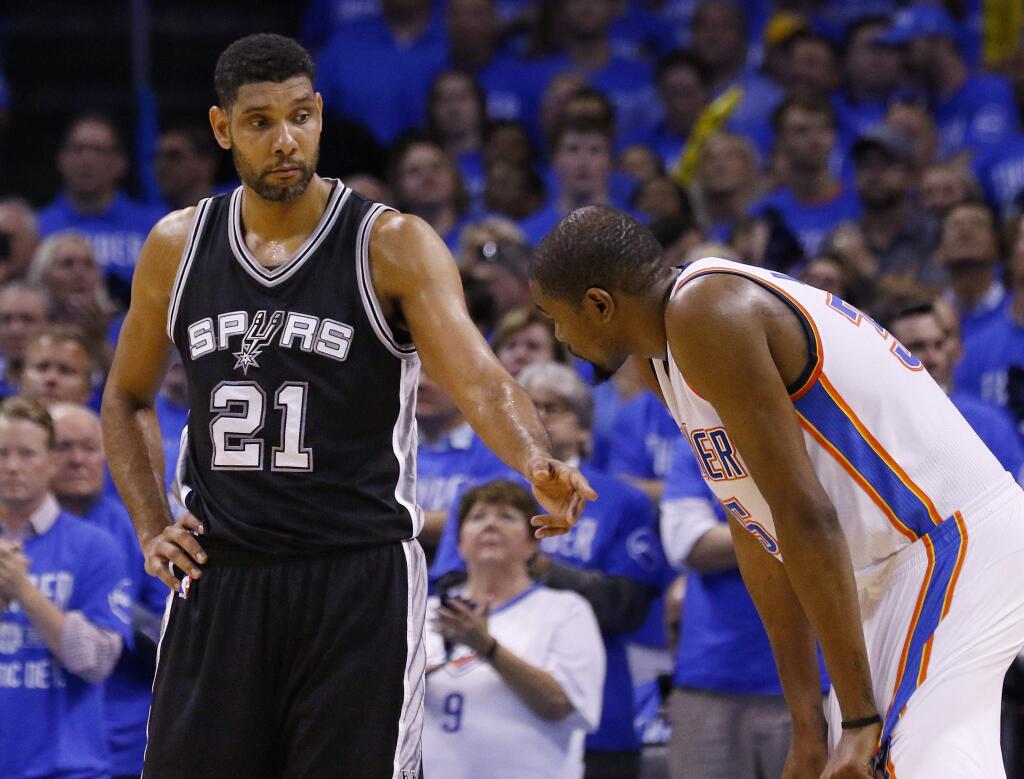 San Antonio Spurs center Tim Duncan (21) talks with Oklahoma City Thunder forward Kevin Durant, right, during the fourth quarter of Game 6 of a second-round NBA basketball playoff series in Oklahoma City, Thursday, May 12, 2016. Oklahoma City won 113-99 and moves on to the Western Conference finals. (AP Photo/Alonzo Adams)