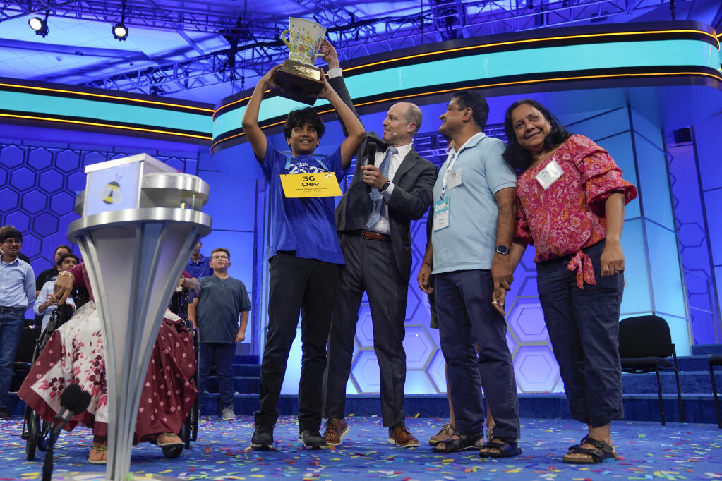 Dev Shah, 14, from Largo, Fla., celebrates winning the Scripps National Spelling Bee alongside his family, Thursday, June 1, 2023, in Oxon Hill, Md. (AP Photo/Nathan Howard)