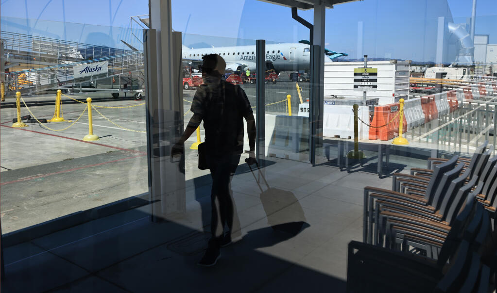 A new breezeway protects passenger from the elements after deplaning at the Charles M. Schulz-Sonoma County Airport in Santa Rosa. A ceremony was held at the facility, Wednesday, Aug. 23, 2023, to celebrate the completion of the airport expansion. (Kent Porter / The Press Democrat file)