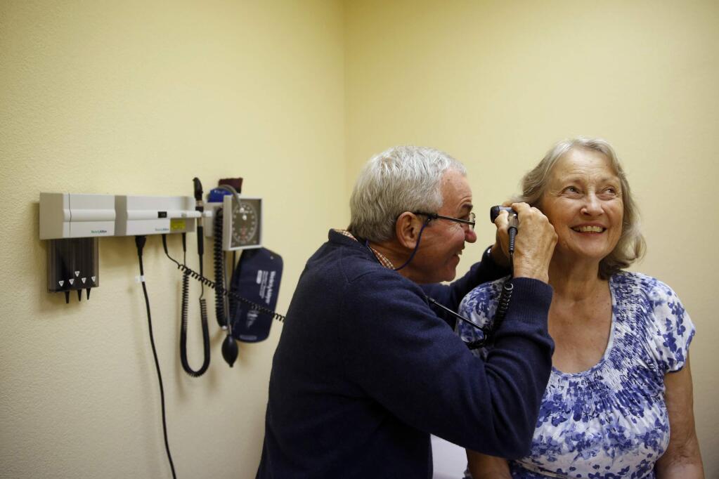 Dr. Greg Rosa, a family medicine doctor, conducts a pre-operative check-up on Laura Van Gorder at their medical office in Sebastopolon Monday, Sept. 8, 2014. (BETH SCHLANKER / The Press Democrat)