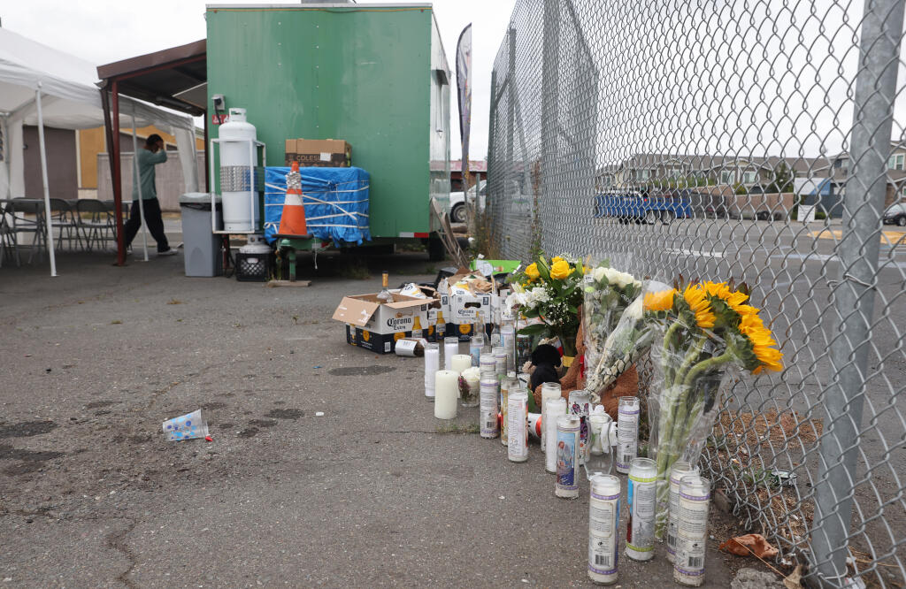 Flowers for a man fatally shot in the parking lot of the Whiskey Tip nightclub on Sebastopol Road on Saturday night are placed along the parking lot fence in Santa Rosa on Monday, September 27, 2021.  (Christopher Chung/ The Press Democrat)