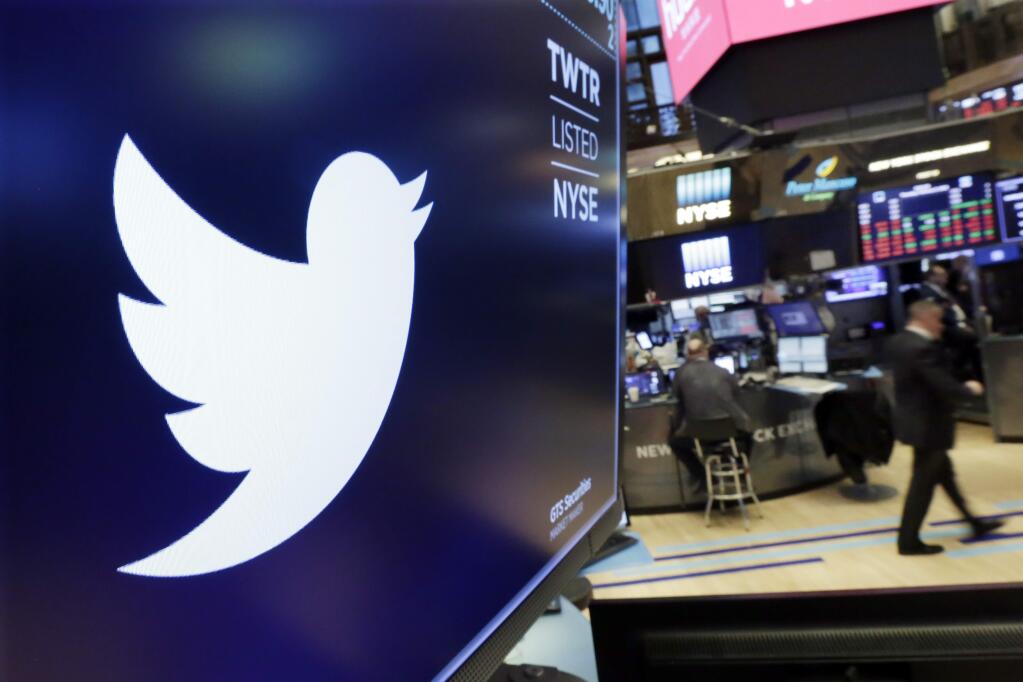 The logo for Twitter is displayed above a trading post on the floor of the New York Stock Exchange, Thursday, Feb. 8, 2018. Twitter is reporting fourth-quarter net income of $91.1 million, swinging to a profit a year after reporting millions in losses last year. (AP Photo/Richard Drew)