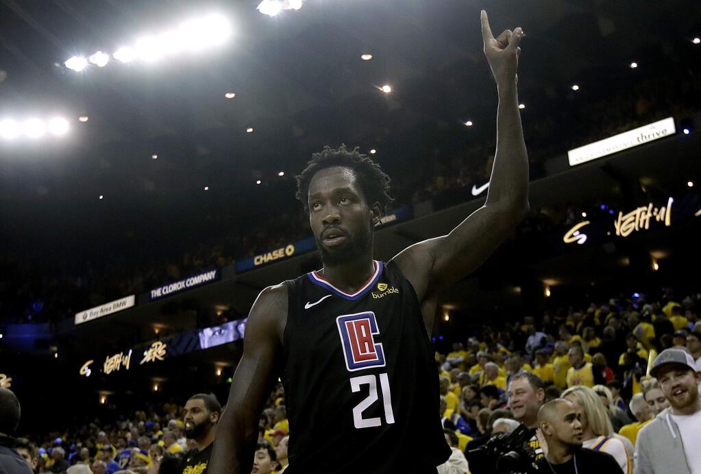 FILE - In this April 15, 2019, file photo, Los Angeles Clippers guard Patrick Beverley celebrates during the second half of Game 2 of a first-round NBA basketball playoff series against the Golden State Warriors in Oakland, Calif. No more watching other teams go deep in the playoffs. The NBA's balance of power has shifted to the Clippers, who have never advanced beyond the second round let alone won a championship. The Clippers are favorites to win it all, a stunning shift for a franchise that has spent much of its existence as a punch line. (AP Photo/Jeff Chiu, File)