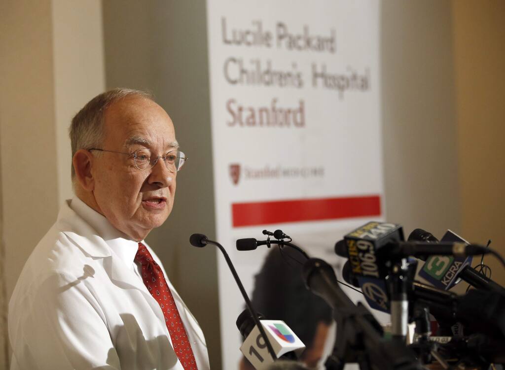 Pediatric surgeon Gary Hartman addresses the media after surgery on conjoined twins in 2016 at the Lucile Packard Children's Hospital in Palo Alto. Proposition 4 on the Nov. 6 ballot is a $1.5 billion bond act to add capacity and upgrade equipment at children's hospitals. (TONY AVELAR / Associated Press)