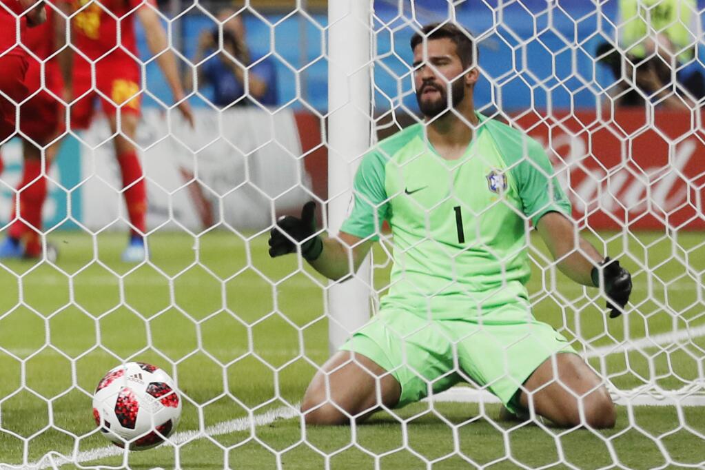 Brazil goalkeeper Alisson reacts after Brazil's Fernandinho scored an own goal, the first for Belgium side's during the quarterfinal match between Brazil and Belgium at the 2018 soccer World Cup in the Kazan Arena, in Kazan, Russia, Friday, July 6, 2018. (AP Photo/Frank Augstein)