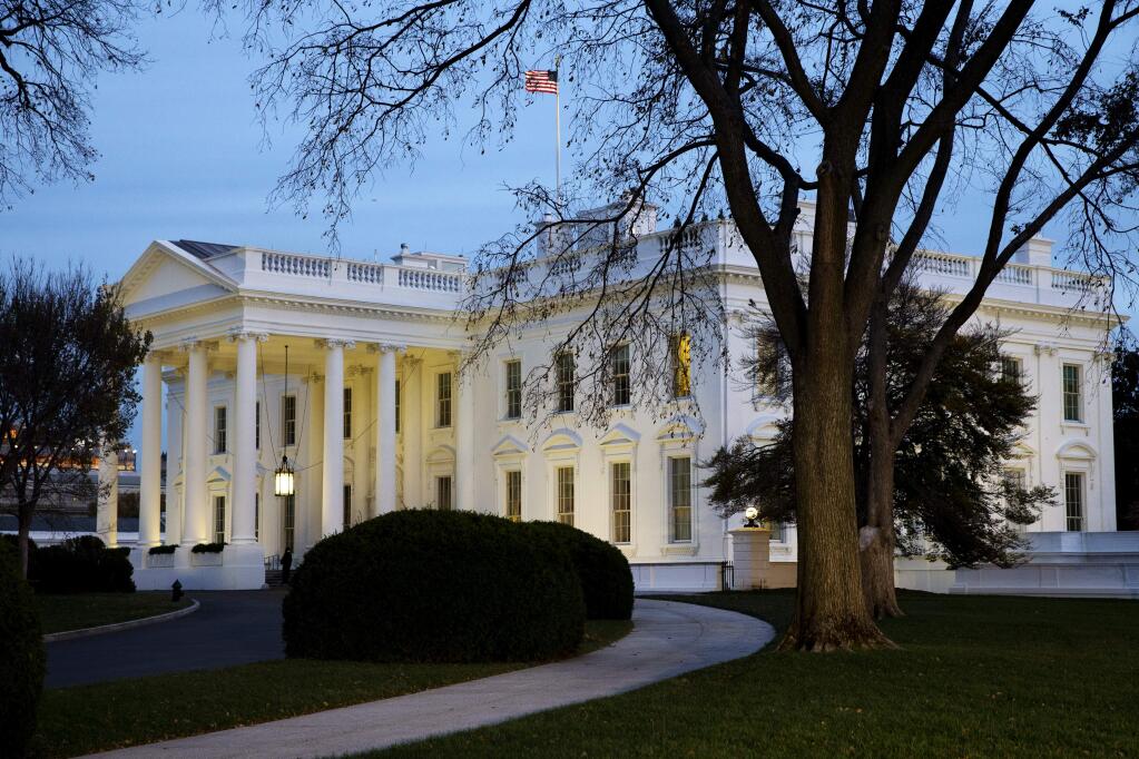 The White House is seen at dusk in Washington, Wednesday, Nov. 19, 2014. (AP Photo/Jacquelyn Martin)