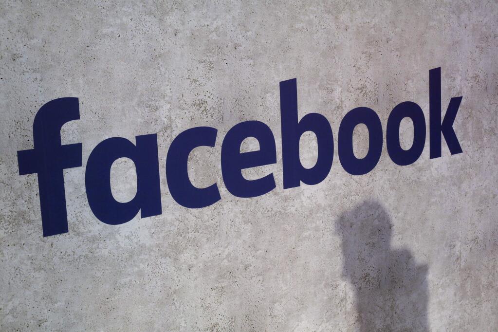 File - This Jan. 17, 2017, file photo shows a Facebook logo being displayed in a start-up companies gathering at Paris' Station F, in Paris. A former employee of a Trump-affiliated data-mining firm says it used algorithms that 'took fake news to the next level' using data inappropriately obtained from Facebook. (AP Photo/Thibault Camus, File)
