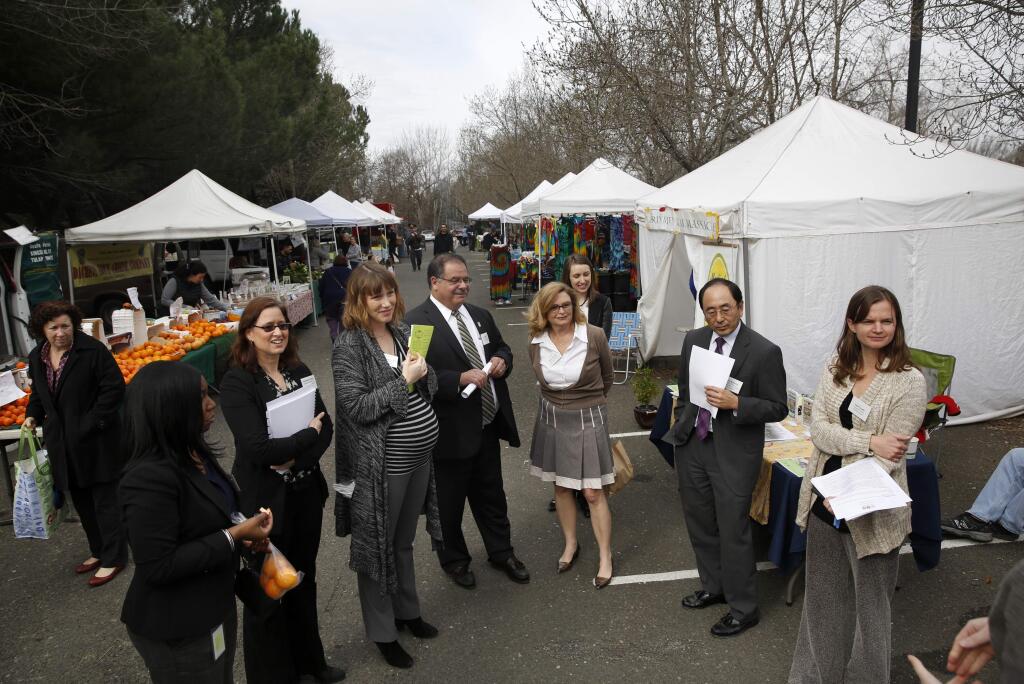 Elece Hempel, board president of the Petaluma Health Care District, third from right, joins a group visiting the East-Side Farmers Market on a tour Tuesday of the Petaluma Health Care District. Photo taken at the Petaluma Community Center. (BETH SCHLANKER / The Press Democrat)