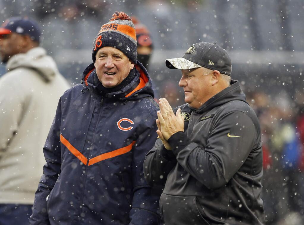 Chicago Bears head coach John Fox and San Francisco 49ers head coach Chip Kelly talk on the field before a game, Sunday, Dec. 4, 2016, in Chicago. (AP Photo/Charles Rex Arbogast)