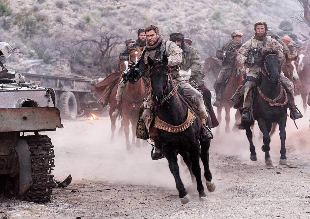 Chris Hemsworth, center, leads a group of Americans sent to Afghanistan after the 9/11 attacks to join forces with the Afghan Northern Alliance in a war against the Taliban, based on a true story. (WARNER BROS. PICTURES)