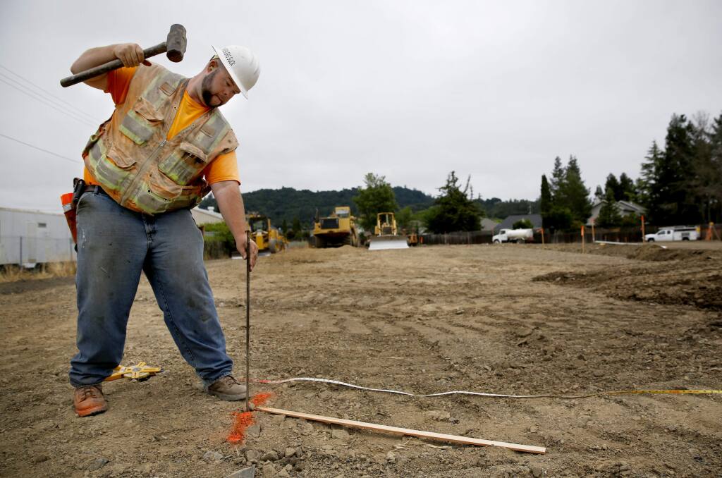Mike Gayski, a grading foreman with Northwest General Engineering, drives in stakes to set the grade as construction gets underway on a 30-unit apartment complex for low income farmworkers. Photo taken in Santa Rosa, on Tuesday, June 7, 2016. (BETH SCHLANKER/ The Press Democrat)