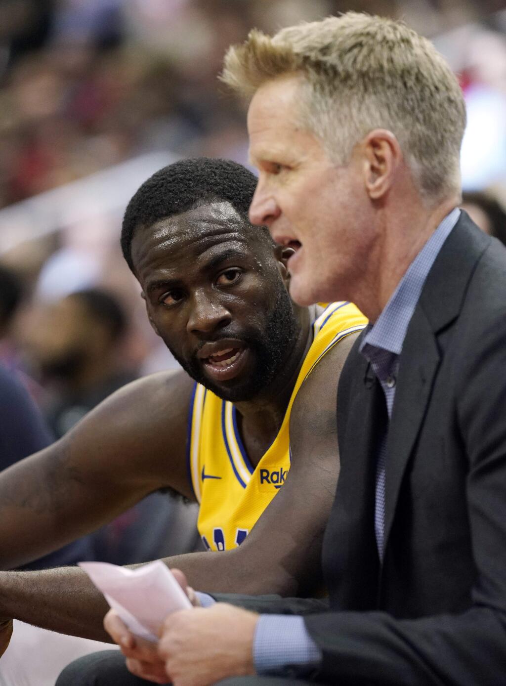 The Golden State Warriors' Draymond Green, left, listens to coach Steve Kerr during the second half against the Houston Rockets Thursday, Nov. 15, 2018, in Houston. The Rockets won 107-86. (AP Photo/David J. Phillip)