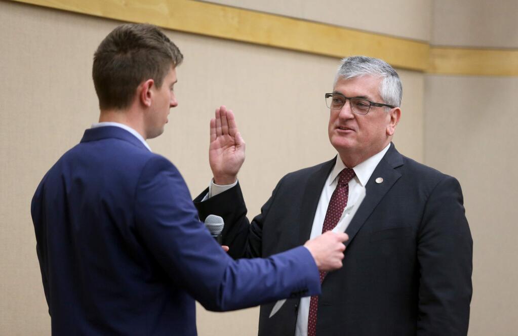 Supervisor David Rabbitt is sworn into office by his son Pat during the Sonoma County Board of Supervisors meeting in Santa Rosa on Tuesday, January 8, 2019. (BETH SCHLANKER/ The Press Democrat)