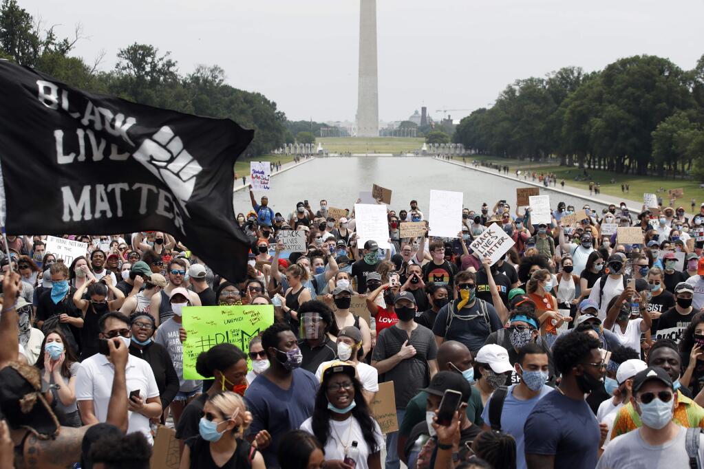 FILE - In this June 6, 2020, file photo, demonstrators protest at the Lincoln Memorial in Washington, over the death of George Floyd, a Black man who was in police custody in Minneapolis. (AP Photo/Alex Brandon, File)