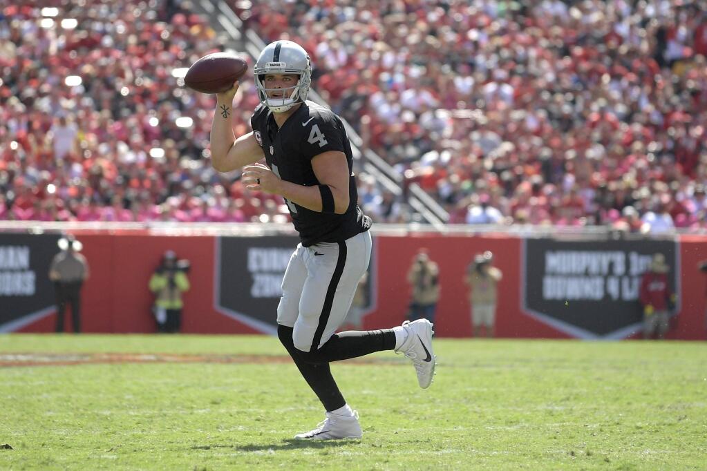 Oakland Raiders quarterback Derek Carr rolls out to throw a pass during the first half against the Tampa Bay Buccaneers in Tampa, Fla., Sunday, Oct. 30, 2016. (AP Photo/Phelan M. Ebenhack)