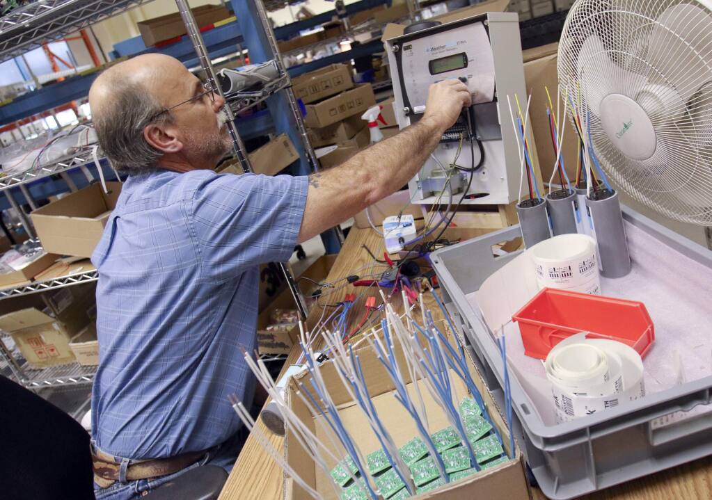 Brian Parker tests parts for flow link controllers while doing assembly at Hydropoint in Petaluma on Monday, April 27, 2015. (SCOTT MANCHESTER/ARGUS-COURIER STAFF)