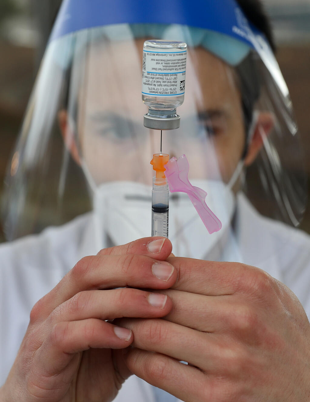 Safeway pharmacy manager Gunner Olsen prepares a syringe with the Moderna COVID-19 vaccination in Santa Rosa on Wednesday, Jan. 13, 2021. (Christopher Chung / The Press Democrat)