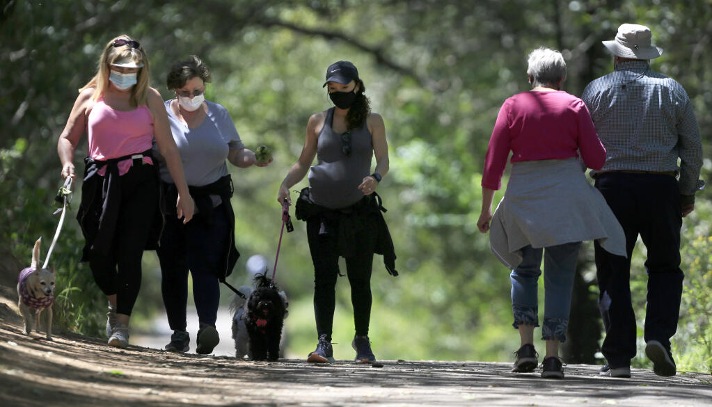 From left, Susan Saludes, Suzanne Alverio and Bernadette Alverio take advantage of the warm spring day for exercise at Howarth Park in Santa Rosa, Tuesday, April 27, 2021. (Kent Porter / The Press Democrat) 2021