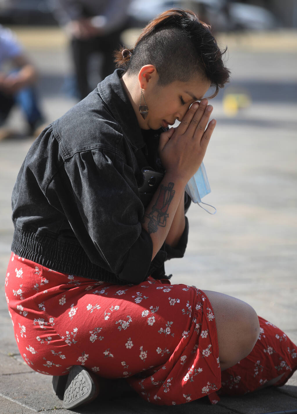 Chantavy Tornado, who is Khmer and a co-organizer of "Game Over," says a prayer during an event denouncing violence against Asian Americans at Old Courthouse Square in Santa Rosa, Saturday Feb. 20, 2021.  (Kent Porter / The Press Democrat) 2021