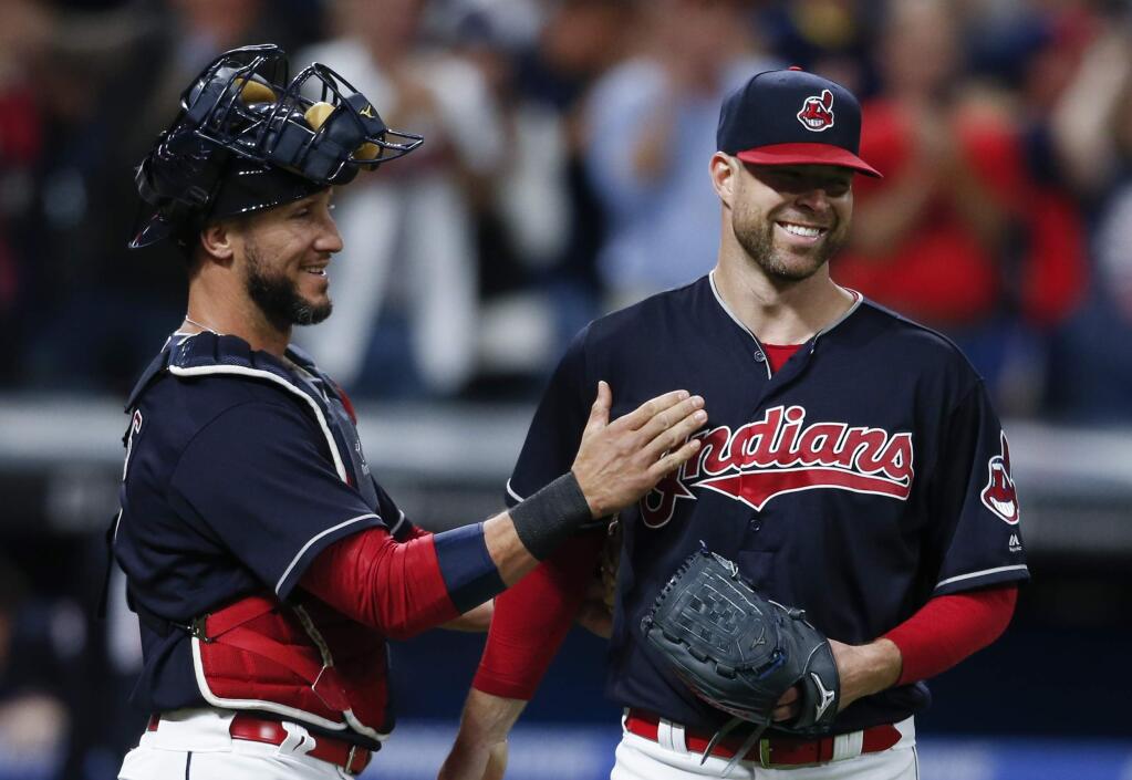 Cleveland Indians starting pitcher Corey Kluber, right, and catcher Yan Gomes celebrate a 2-0 victory over the Detroit Tigers in a baseball game, Tuesday, Sept. 12, 2017, in Cleveland. (AP Photo/Ron Schwane)